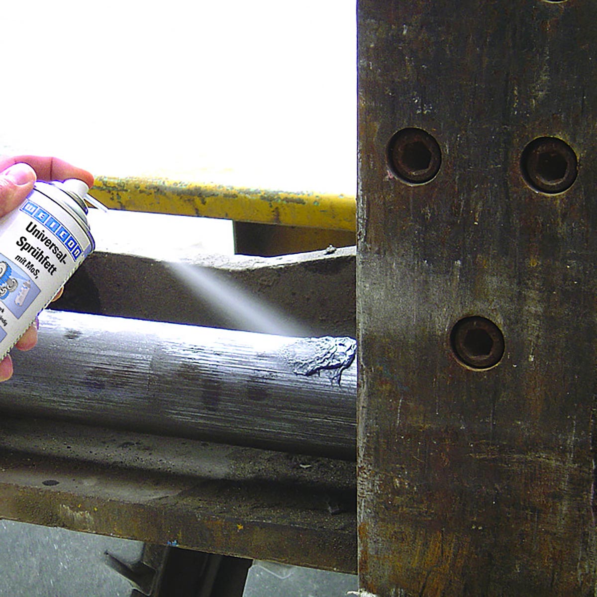 Wooden fence joint being lubricated with Weicon Universal Spray-On Grease MoS2